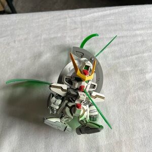 Robot Action Figure with Green and Red Accents Gundam